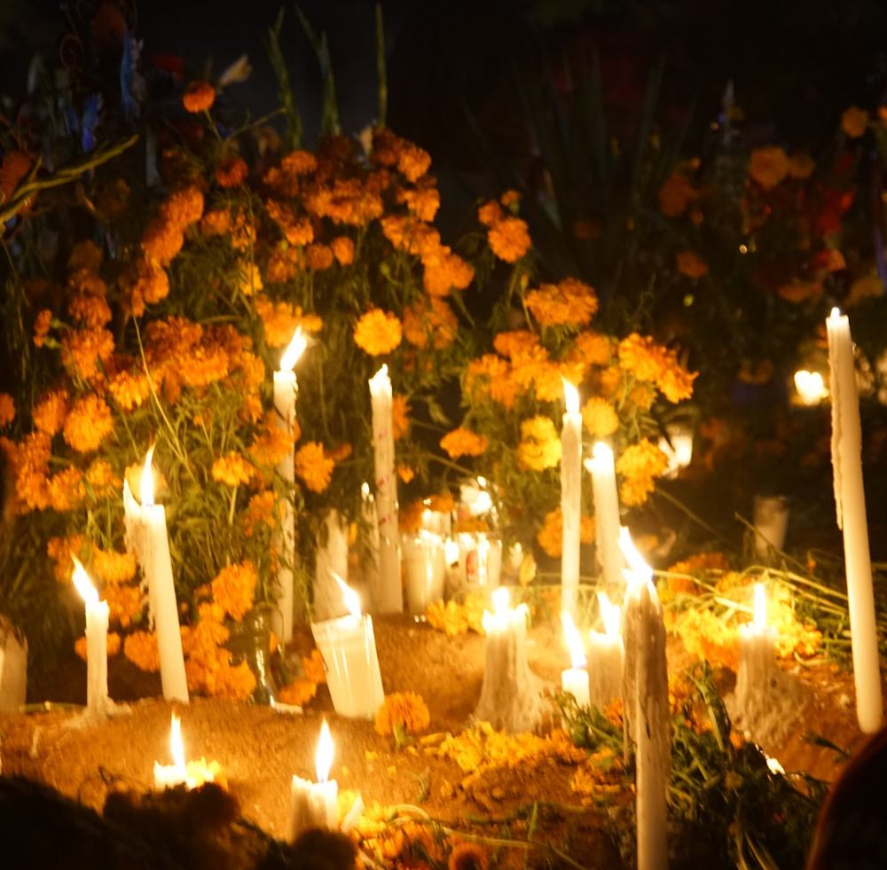Candles and marigolds on graves at night in the cemetery of Huautla de Jiménez during S'ui K'ien